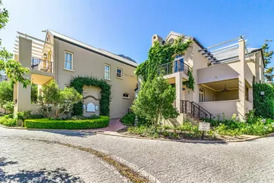 a house with a cobblestone street in front of it at L'Ermitage Chateau and Villas at Villa 80 in Franschhoek