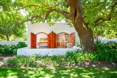a bath tub sitting in a yard next to a tree at The Oak Cottage in Wellington