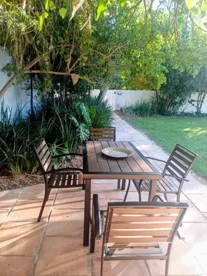 a wooden table and two chairs and a table and chairs at GreenPeace in Stellenbosch