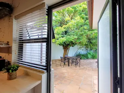 a sliding glass door leading to a patio with a table at GreenPeace in Stellenbosch