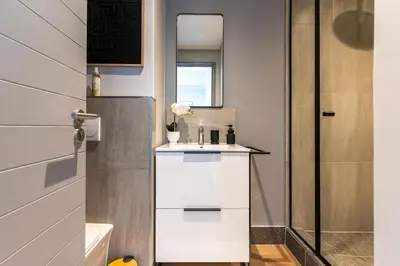 a small bathroom with a sink and a shower at Stylish Executive Studio with Balcony in Riverlands, Observatory in Cape Town