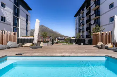 a swimming pool in front of a building at Stylish Executive Studio with Balcony in Riverlands, Observatory in Cape Town