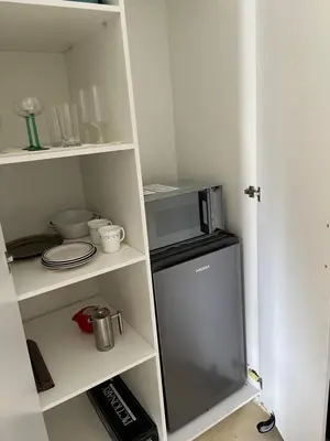 a kitchen with a refrigerator and a microwave at BEACH FRONT Side Studio, 50 steps to main beach in Pringle Bay