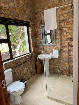 a bathroom with a toilet and a sink at BEACH FRONT Side Studio, 50 steps to main beach in Pringle Bay
