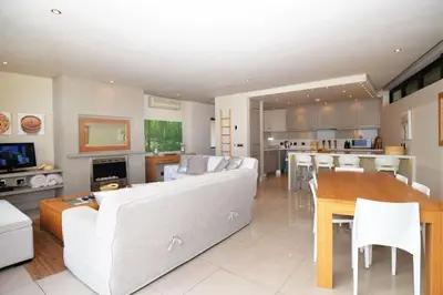 a large living room with a couch and a table at bamboo @ Le Paradis in Hermanus