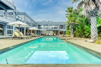 an exterior view of a house with a swimming pool at Atlantic Palms in Cape Town