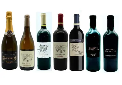 a group of wine bottles sitting next to each other at Domaine Coutelier in Stellenbosch