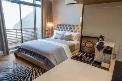 a bedroom with a large bed and a large window at Nicara to Akker Collective in Stellenbosch