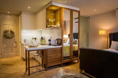 a kitchen with a sink and a room with a bed at Nicara to Akker Collective in Stellenbosch