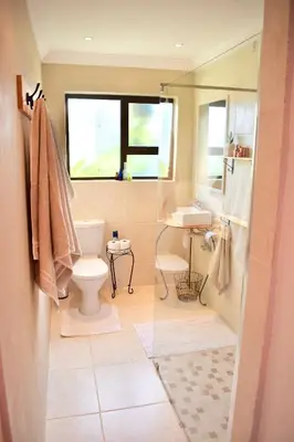 a bathroom with a toilet and a sink at 10 On Ou Kraal in Edgemead