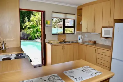 a kitchen with a sink and a refrigerator at 10 On Ou Kraal in Edgemead