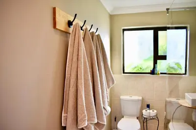 a bathroom with a towel hanging on a wall at 10 On Ou Kraal in Edgemead