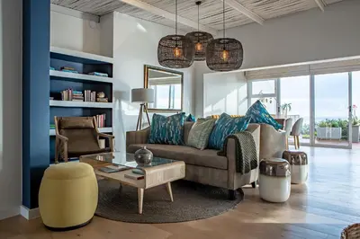 a living room with a couch and a table at Villa Marine Guest House in Pringle Bay