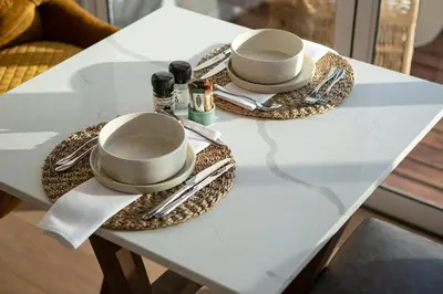a table with two cups and utensils on it at Villa Marine Guest House in Pringle Bay