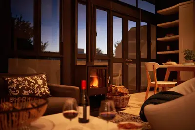 a living room with a couch and a table with wine glasses at 22 Eikehoff Apartment in Stellenbosch
