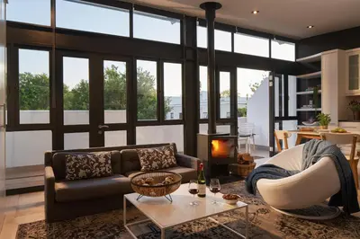 a living room with a couch and a fireplace at 22 Eikehoff Apartment in Stellenbosch