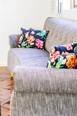 a couch with two pillows on it in a living room at Skyview Manor in Stellenbosch