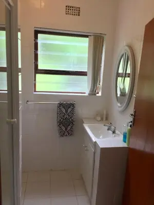 a bathroom with a sink and a window at Hermanus Heights Villa in Hermanus