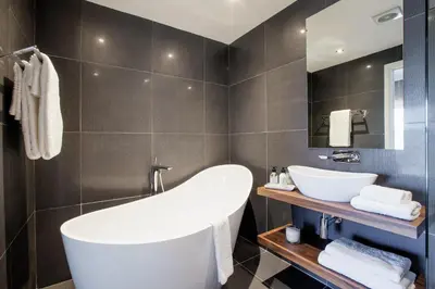 a bathroom with a white tub and a sink at Bliss Boutique Hotel in Cape Town