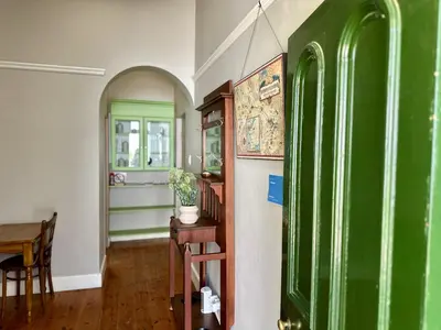 a room with a green refrigerator and a table at Le Manse in Franschhoek