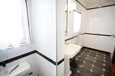 a white bathroom with a sink and a toilet at Beckhuis in Worcester