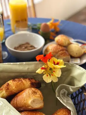 a table with a tray of pastries and flowers on it at Marshden Estate in Stellenbosch