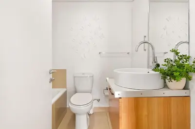 a bathroom with a white toilet and a sink at Horizon Bay 103 in Bloubergstrand