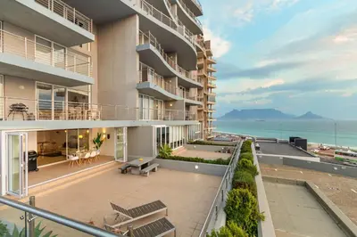 an apartment building with a view of the ocean at Horizon Bay 103 in Bloubergstrand