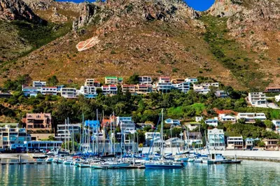 a bunch of boats are docked in a harbor at Bikini Beach Holiday Home, On the Beach, Sleeps 9! in Gordonʼs Bay