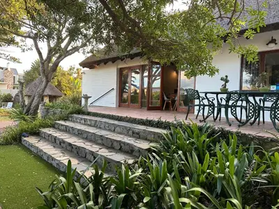 a patio with stairs leading to a house at House on Westcliff in Hermanus