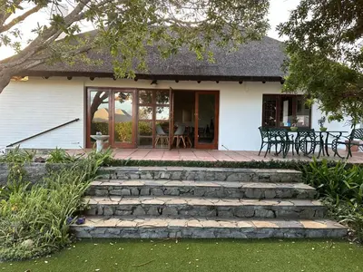 a house with stairs leading to a patio at House on Westcliff in Hermanus