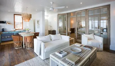a living room with a couch and a table at Akademie Street Boutique Hotel in Franschhoek