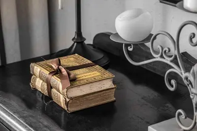 two old books sitting on a table next to a lamp at Wild Olive Guest House & Villa in Cape Town