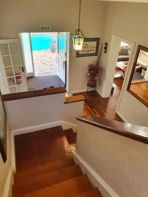 a staircase in a home with a view of the beach at Wild Olive Guest House & Villa in Cape Town