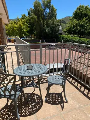 a table and two chairs sitting on a patio at Oak Tree Lodge in Paarl