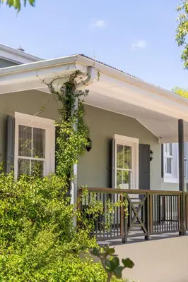 a house with a porch and a deck at Protea Hotel by Marriott Franschhoek in Franschhoek