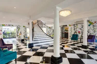 a lobby with a black and white checkered floor at Protea Hotel by Marriott Franschhoek in Franschhoek