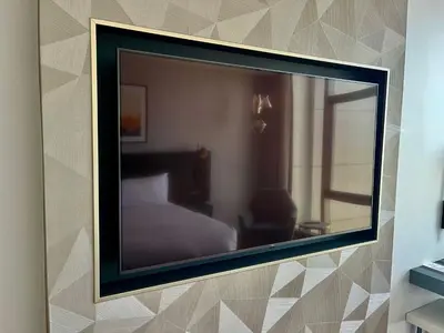 a mirror hanging on a wall with a bedroom at Cape Town Marriott Hotel Crystal Towers in Cape Town