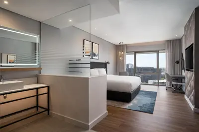 a hotel room with a bed and a sink at Cape Town Marriott Hotel Crystal Towers in Cape Town