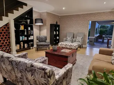a living room with couches and a coffee table at Plumwood Boutique Hotel by The Living Journey Collection in Franschhoek