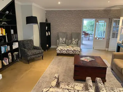 a living room with a couch and a coffee table at Plumwood Boutique Hotel by The Living Journey Collection in Franschhoek