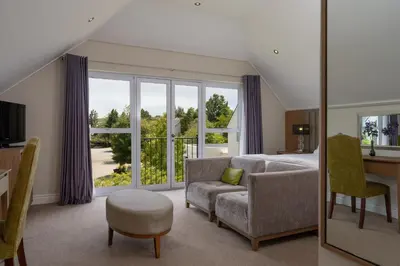 a living room with a couch and a window at Wild Mushroom Country House in Stellenbosch