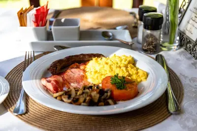 a plate of breakfast food on a table at Evergreen Manor and Spa in Stellenbosch
