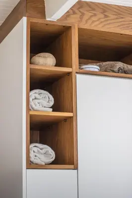 a closet with wooden shelves and towels in it at Le Grenier Luxury Loft in Franschhoek