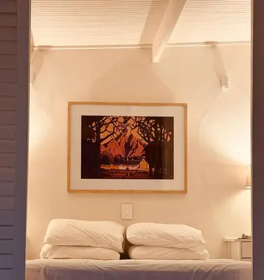 a bedroom with a picture above a bed at Le Grenier Luxury Loft in Franschhoek