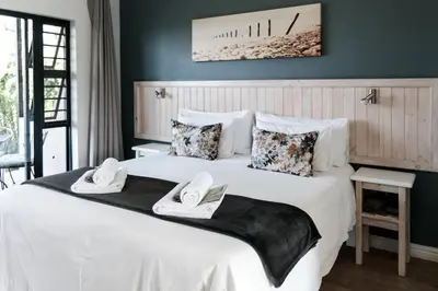 a bedroom with a large white bed with towels on it at Bona Vista Self-Catering Accommodation in Klapmuts