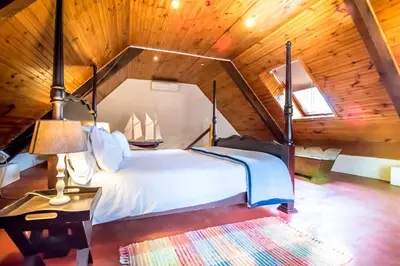 a bedroom with a bed in a wooden cabin at De Leeuwenhof Estate in Paarl