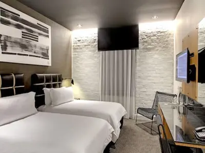 a hotel room with two beds and a desk at Century City Hotel Urban Square in Cape Town