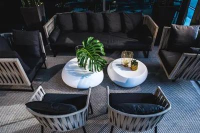 a living room with a couch and a table and chairs at Century City Hotel Urban Square in Cape Town