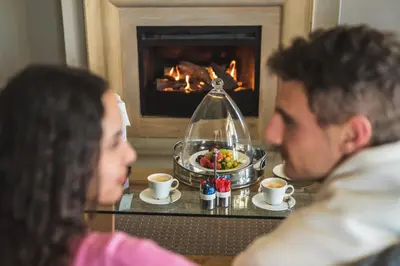 a man and a woman sitting at a table with a bowl of food at ASARA Wine Estate & Hotel in Stellenbosch